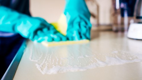 Staff member following safe procedures during a cleaning job
